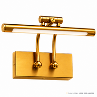 A modern wall-mounted reading light fixture in brushed gold finish, featuring a horizontal bar with an integrated white LED light tube and two curved mounting arms attached to a rectangular wall plate.