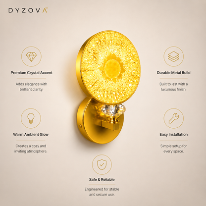 A gold wall-mounted light fixture with a round crystal-like top and warm glowing light, shown on a beige background with feature callouts and the DYZOVA brand name.