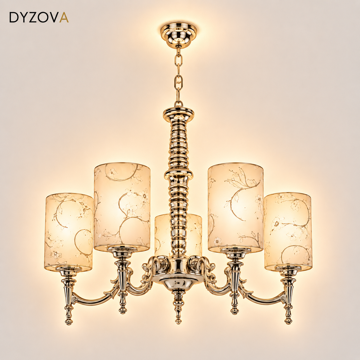 A six-light brass chandelier with decorative scrollwork and cylindrical glass shades featuring a delicate gold leaf pattern, shown against a solid white background.