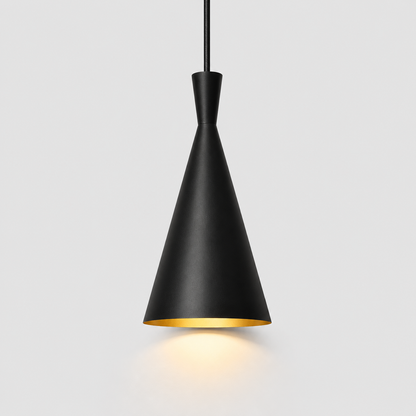 A modern black pendant light with a tapered cone-shaped shade and a gold interior, suspended by a black cord against a light gray background.