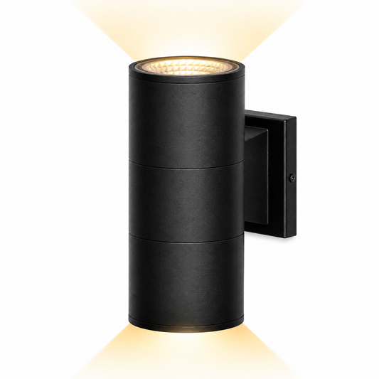A modern black cylindrical outdoor wall light with a warm yellow glow emanating from the top and bottom, shown against a solid white background.