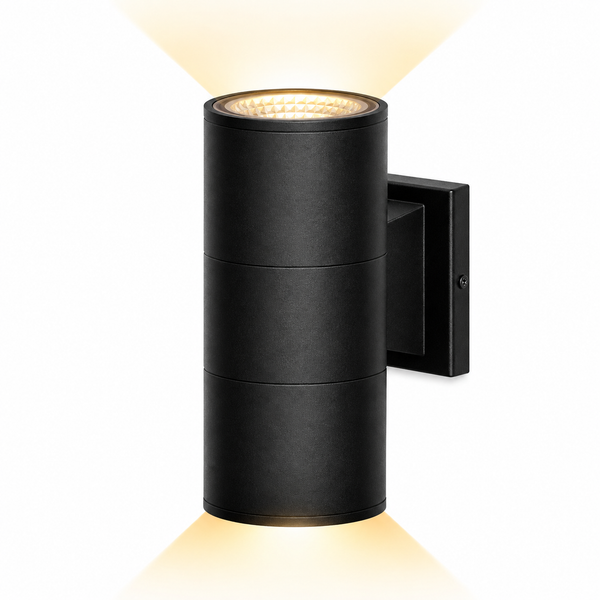 A modern black cylindrical outdoor wall light with a warm yellow glow emanating from the top and bottom, shown against a solid white background.