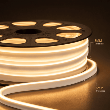 A close-up of a coiled warm white LED light strip on a black spool, with overlaid text labels showing 8MM and 6MM thickness against a dark background.