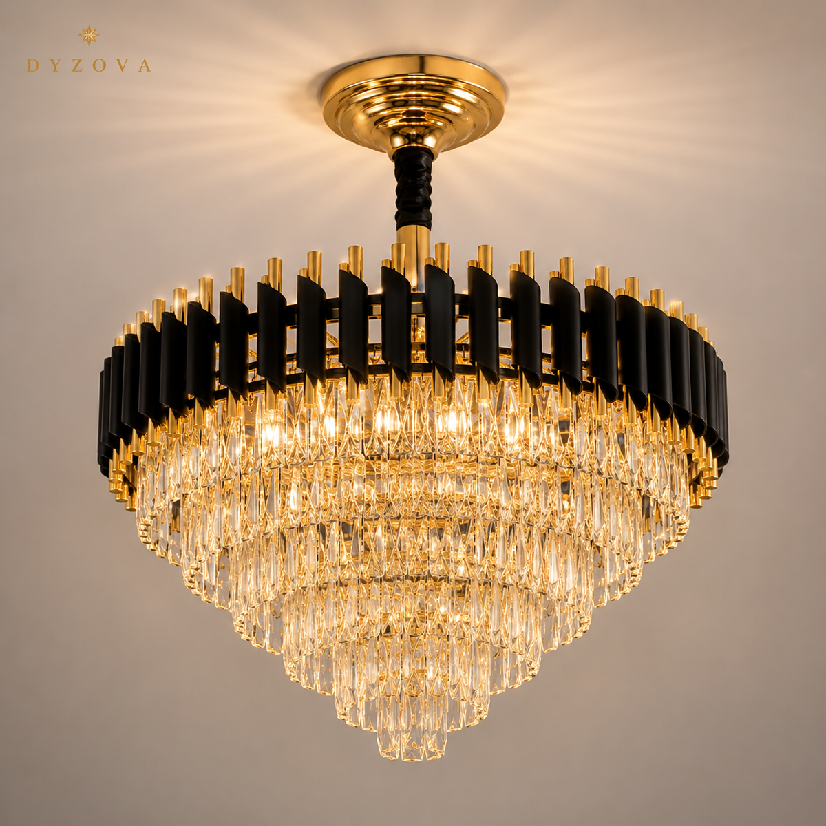 A modern semi-flush mount chandelier by DYZOVA, featuring a circular frame with alternating black and gold vertical bars, a gold ceiling canopy, and cascading clear crystal prisms. The chandelier is shown illuminated against a neutral beige background.